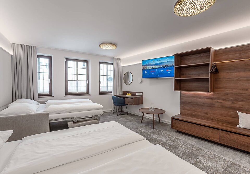 Blick in ein großes, modernes Hotelzimmer.